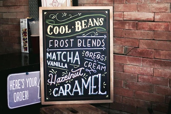 Chalkboard sign displaying a cafe's menu