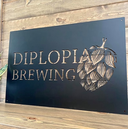 Metal sign for a brewery with a negative space design