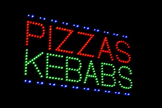LED sign advertising pizza and kebabs