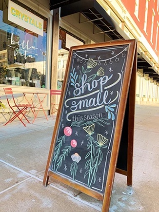 an outdoor hand-drawn chalkboard sign