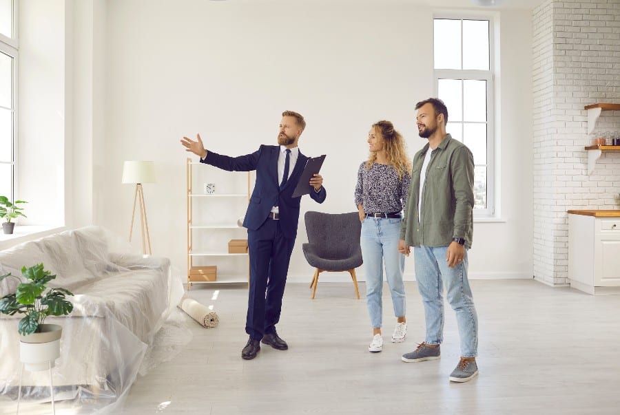 A real estate agent conducting a home tour to a couple.