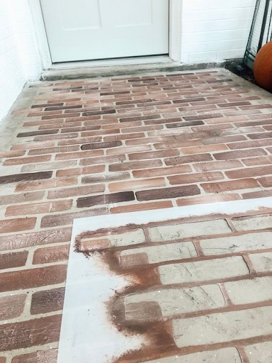 Concrete porch stenciled to look like brick