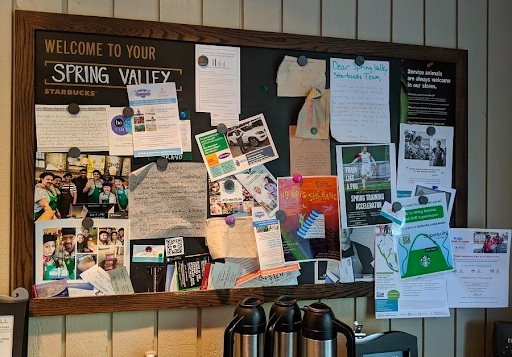 Bulletin board with multiple advertisement pinned in a coffee shop