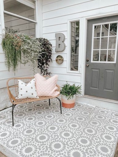 Concrete porch with detailed grey and white stencilled pattern