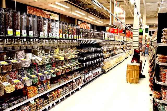 Candy store aisle with candy dispencers.