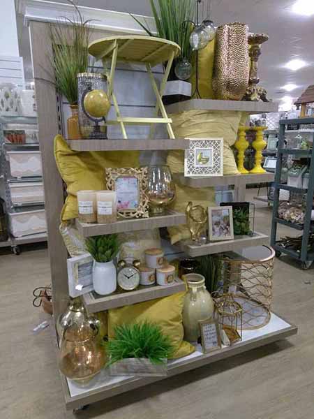 Homegoods endcap display with yellow, green, and beige spring merchandise.