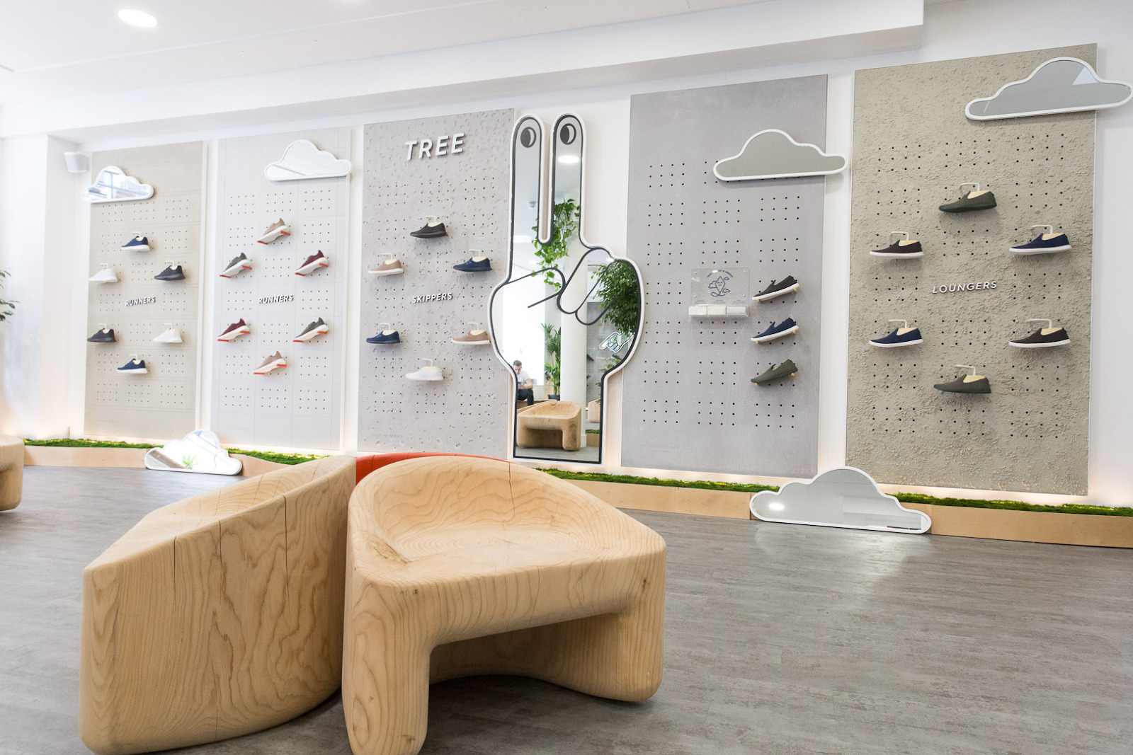 Allbirds visual merchandising display of shoes in retail store.