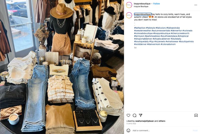 Inspyre Boutique Instagram post with image of fall merchandise on store table display.