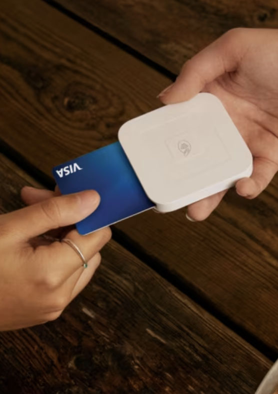 Visa card dipped in Square contactless reader.