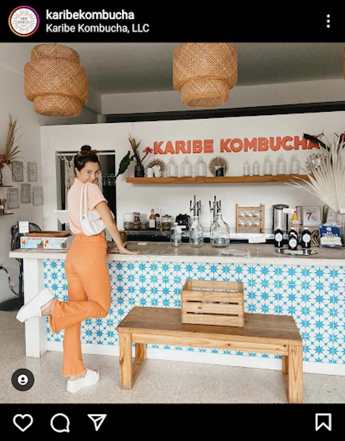 Checkout counter that doubles as a bar with bench seating for drinking kombucha.