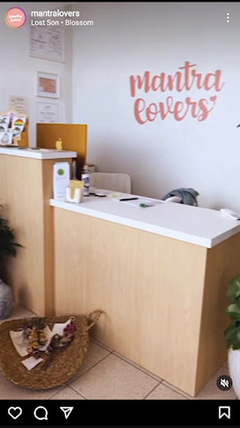 Split-level checkout counter with large "Mantra Lovers" sign painted on wall behind checkout.