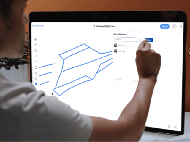 Zoom user drawing a rocket on a touch-screen monitor using Zoom whiteboard.