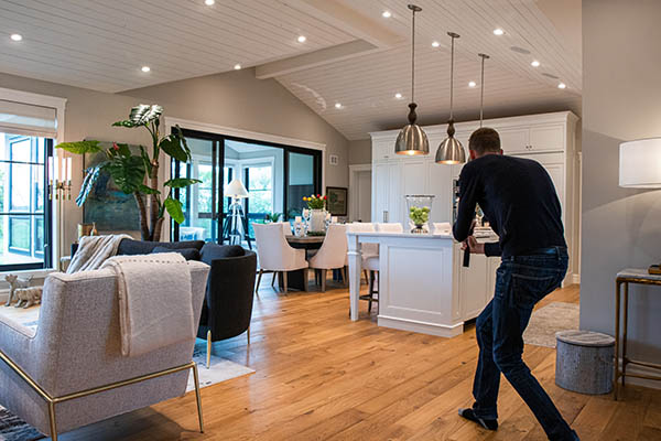 A photographer taking pictures inside an open-concept home.