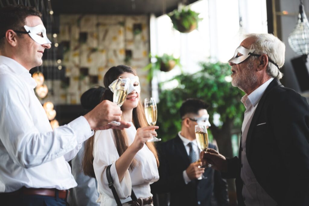 People wearing masquerade masks at a restaurant