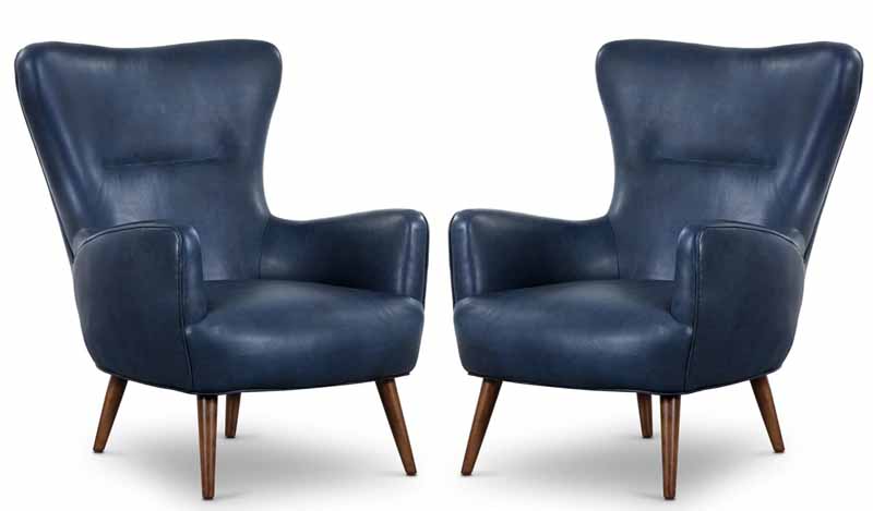 Two navy blue suede armchairs.