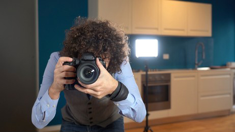 A photographer ready to make a shot with a lighting equipment at the back