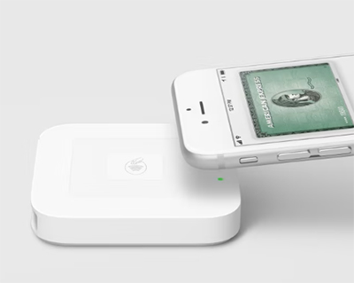 Square reader with smartphone preparing for tap payment.