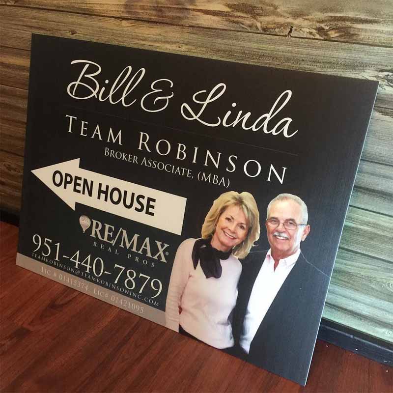 A team real estate open house sign.