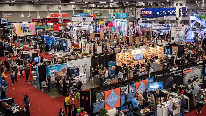 Birds eye view of a busy trade show floor with lots of vendor booths.