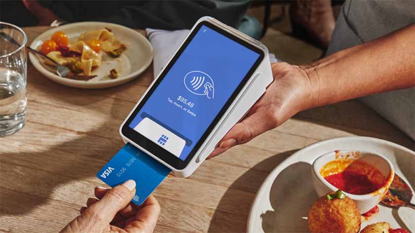Customer paying for their meal with Square's handheld register.