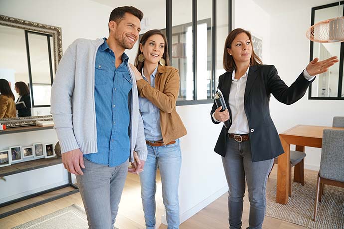 Real estate agent showing house to a couple