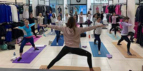 Women gathered for an in-store yoga flow at Gym+Coffee.