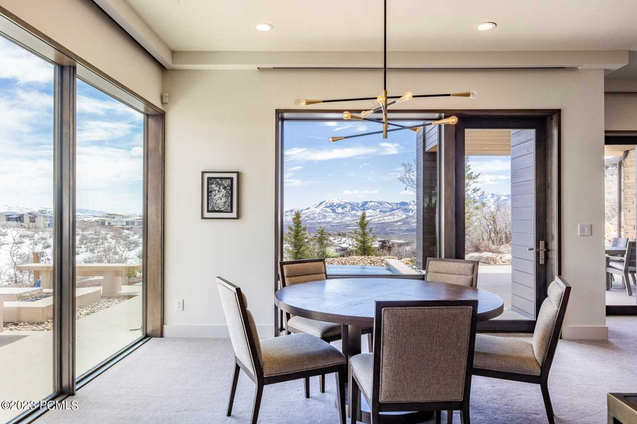 Luxury real estate listing photo of dining room and mountain view.