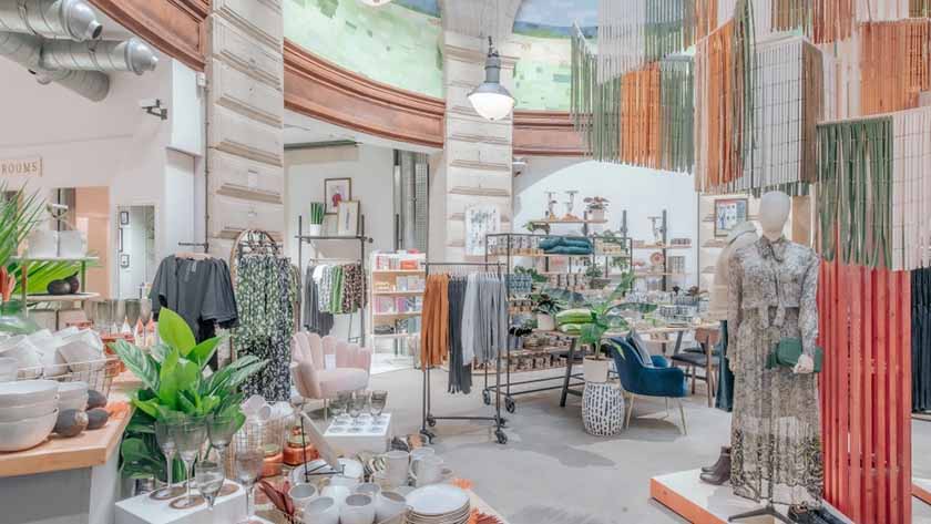 Inside of Anthropologie store, decorated with orange, green, and white for Spring.