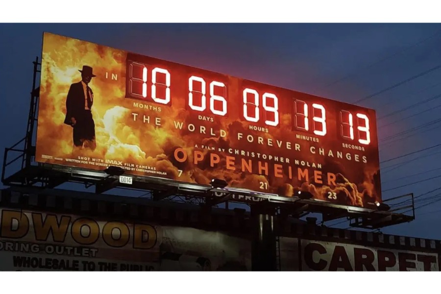 A billboard advertising the movie "Oppenheimer" with a real timer countdown to the premiere.