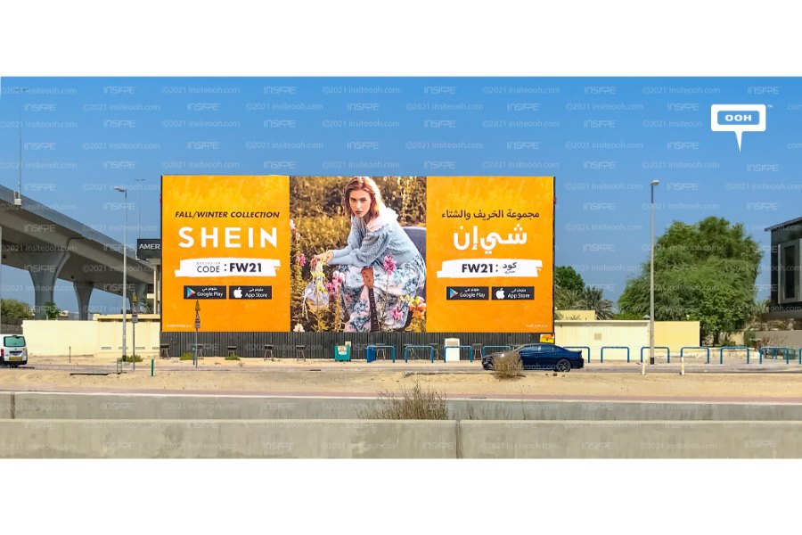 A billboard from the retail brand Shein advertising a promo code.