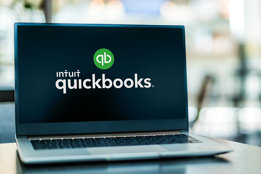 Laptop computer displaying logo of QuickBooks.