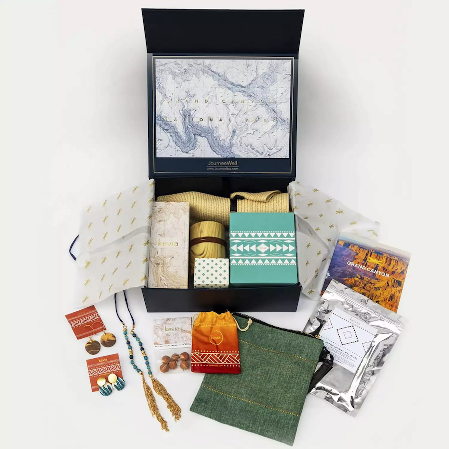Travel-themed subscription box including b lack box with trinkets from around the world.