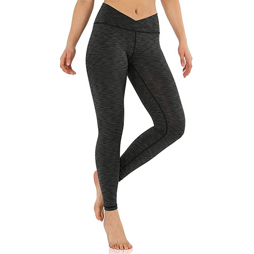 Black heathered cross-waistband leggings on woman in front of white background.