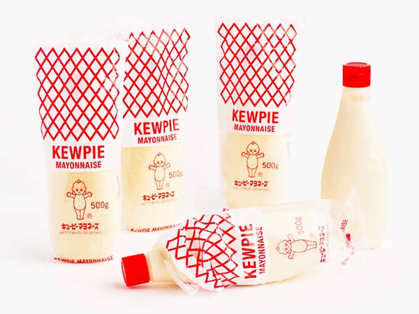 Five Kewpie mayo bottles on a which background, 3 in packaging.