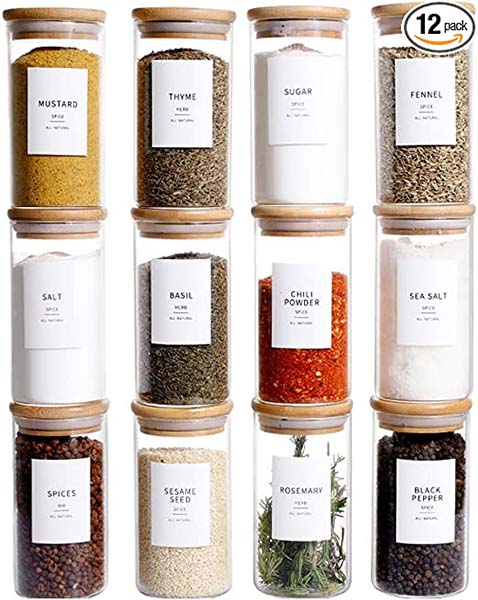 Glass and wood spice containers with uniform labels stacked in four columns of three.