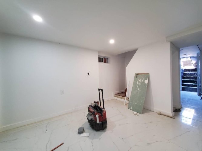 Bad real estate listing photo of an empty room with clutter.