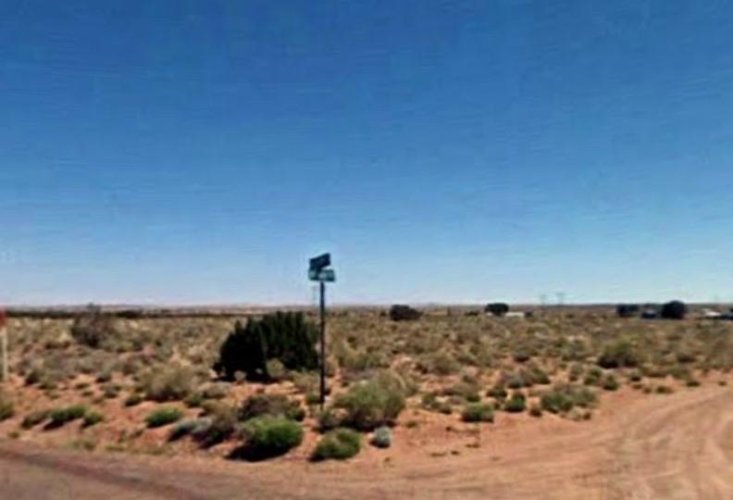 Blurry photo of a street sign and desert