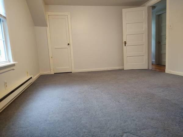 Crooked photo of an empty room for real estate listing.