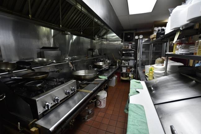 Dark photo of a commercial kitchen.
