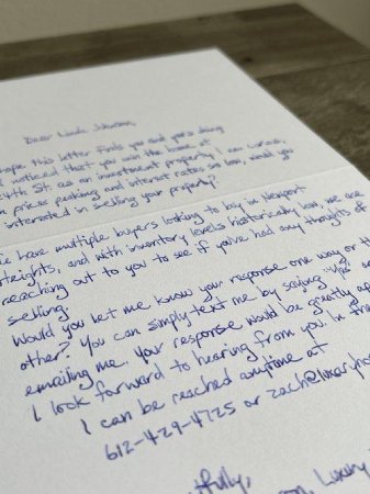 A handwritten note in blue ink on white paper.