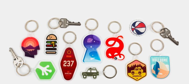 A collection of assorted customizable keychains in various colors, shapes, and designs.