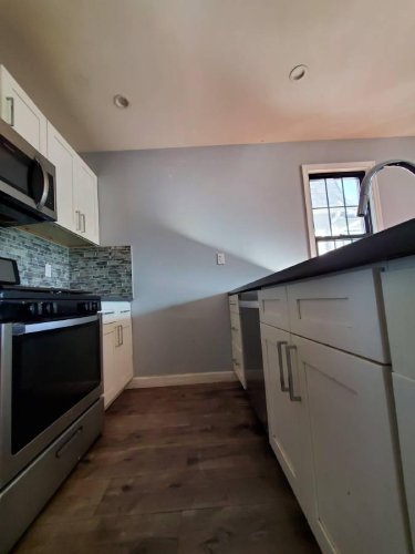 Example of bad kitchen photography showing cabinets and wall.