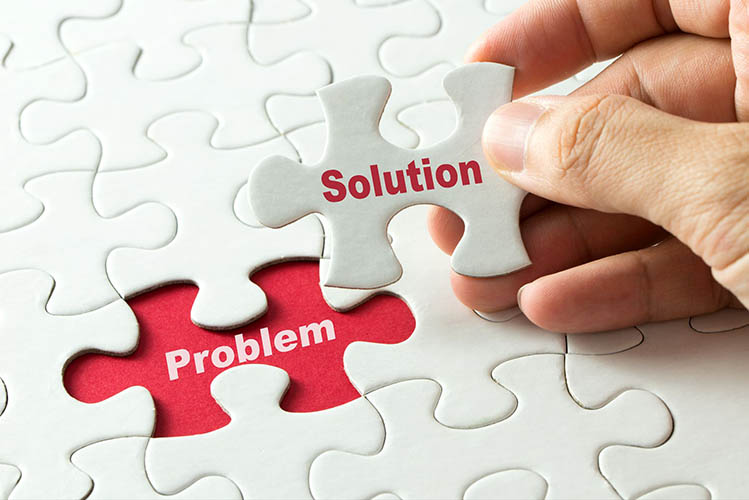 A puzzle with the word "solution" on the missing piece that fits in the space with the word "problem."