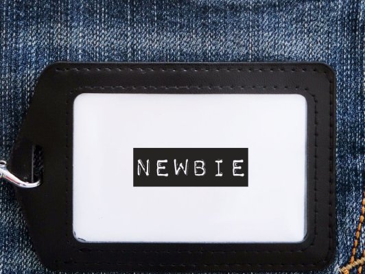 A luggage tag that says, "newbie."