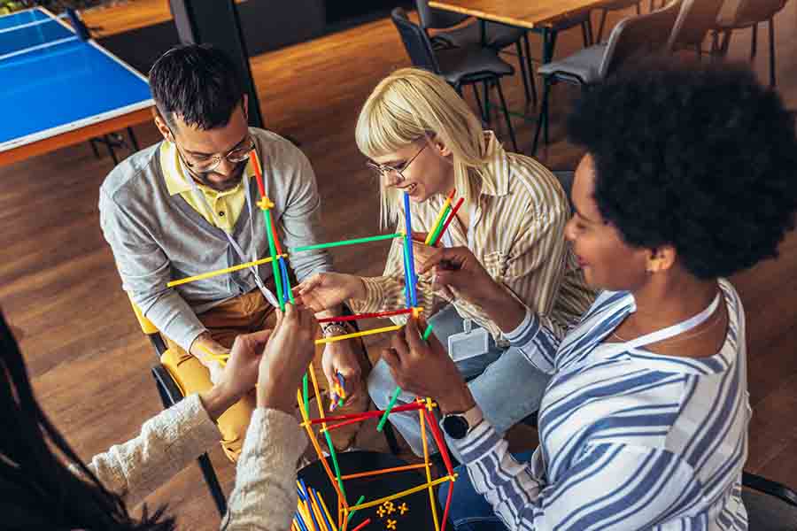 Four people having a team building activity.