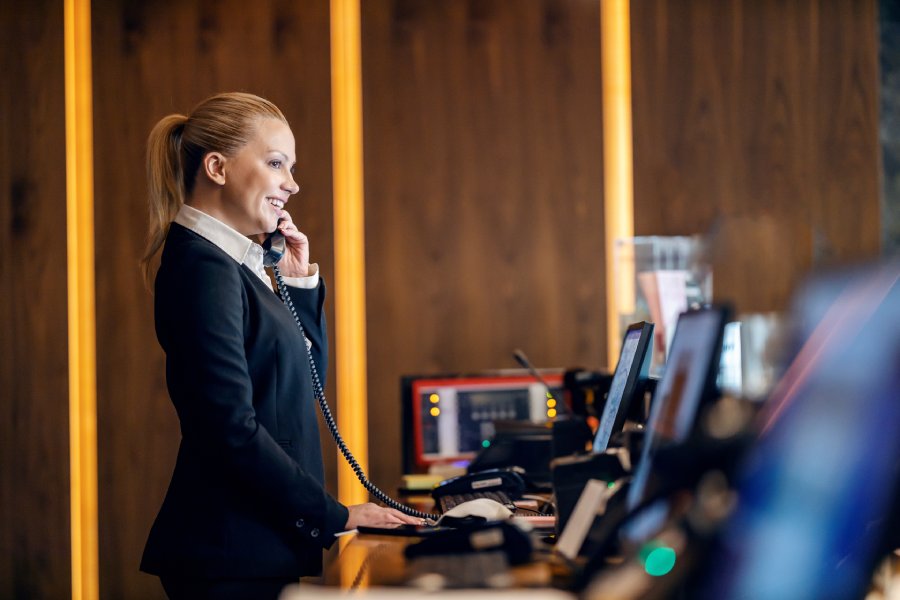 A receptionist using the hotel phone system.