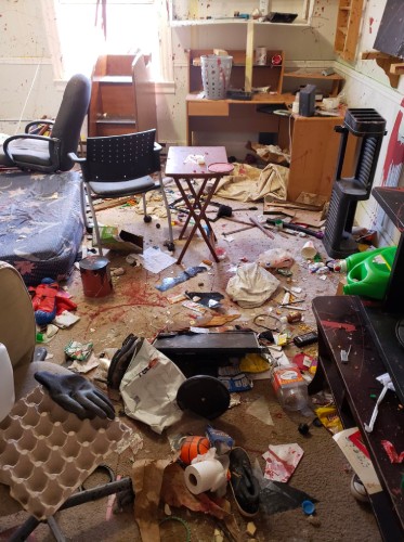 Messy and damaged rental property bedroom.