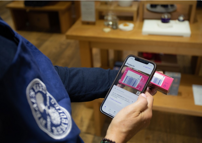 Person using smartphone to scan an item barcode.