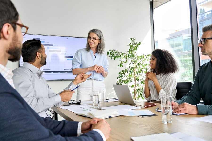 Woman smiling at man in an meeting room.