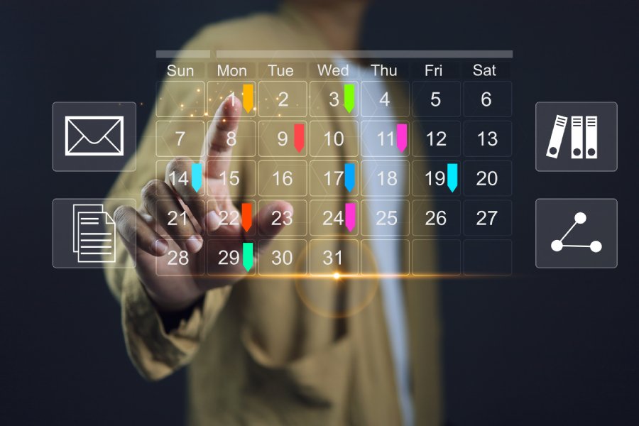 Man setting appointments on calendar or scheduler software.